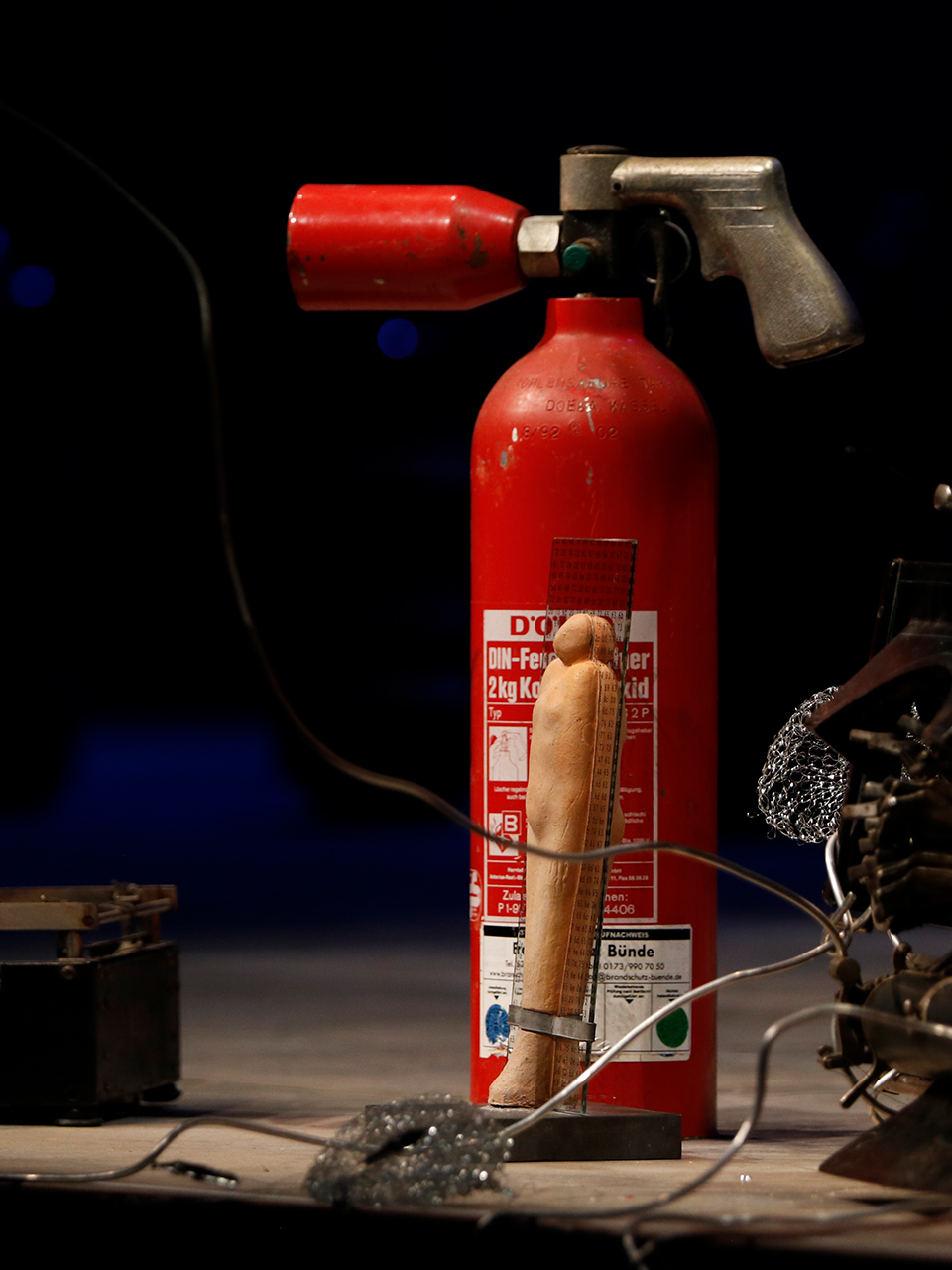 The BBA statue in front of a fire extinguisher on the stage of the city theater in Bielefeld