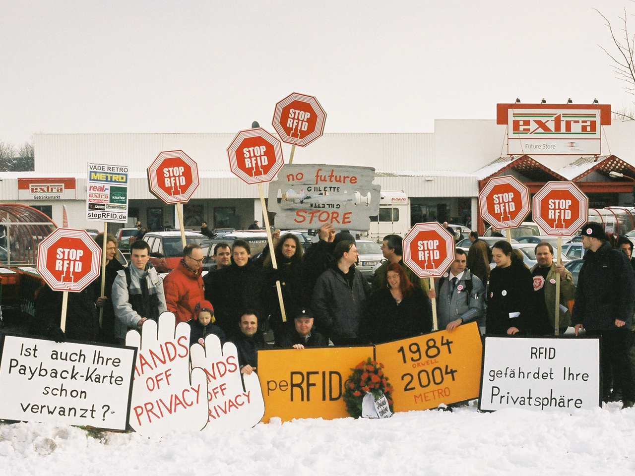 Protesters in front of the Future Store with "Stop RFID" signs