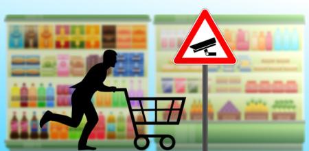 Grafik einer Person, die mit Einkaufswagen durch einen Supermarkt rennt. Vor den bunten regalen ein Schild mit einer Überwachungskamera.