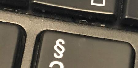 Detailaufnahme einer Tastatur mit dem Paragraphen-Symbol.