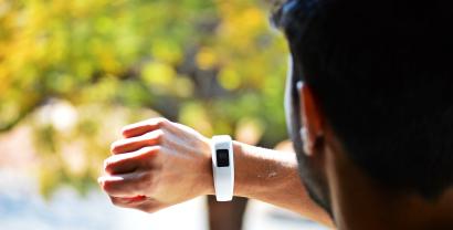 Mann schaut auf Fitbit-Uhr