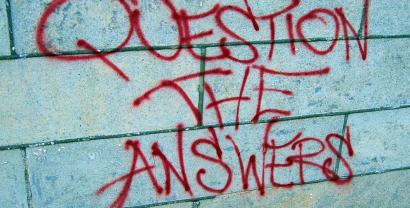 Beschmierte Wand mit dem Satz "Question the answers".