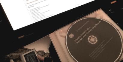 Eine aufgeschlagene CD-Hülle. Auf der CD steht: „Enquete Kommission. Internet und digitale Gesellschaft“. Im Hintergrund ein Laptop-Bildschirm.