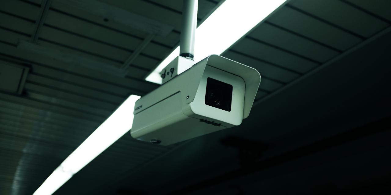 Eine Überwachungskamera, die unter einer Decke hängt.